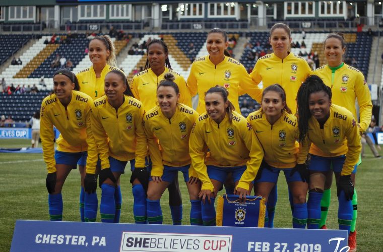 Brazil women’s national football team posing on the pitch