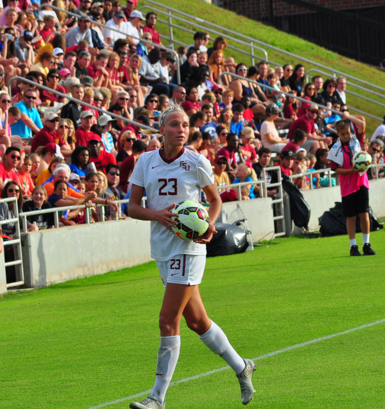 Emma Koivisto holds a football by the touchline in a Florida State University uniform in 2015.