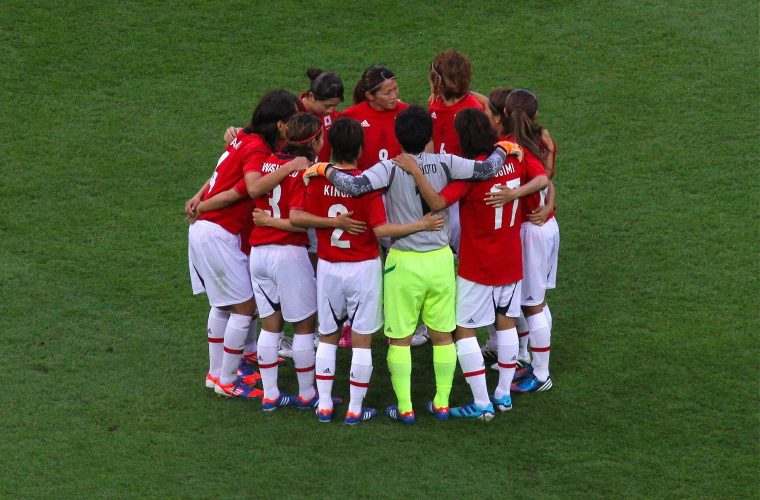 Japan women’s footballers huddling on the pitch